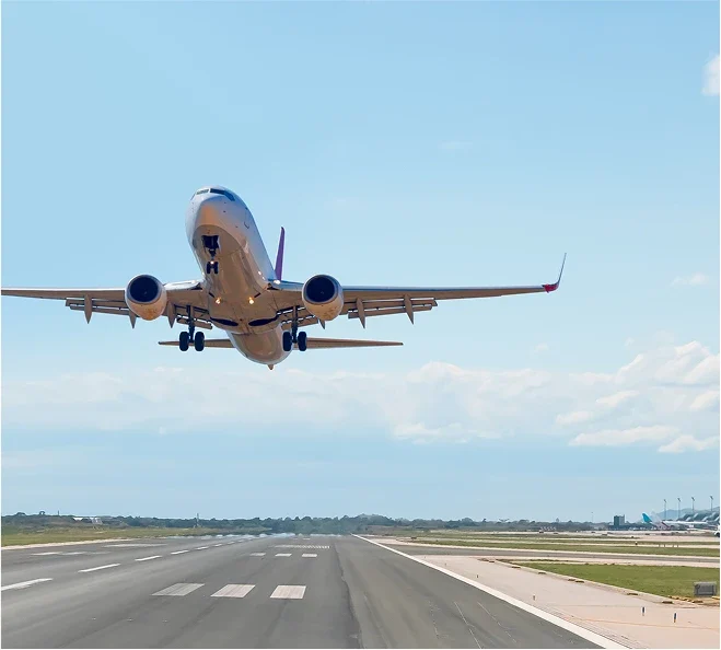 A passenger plane taking off over a runway