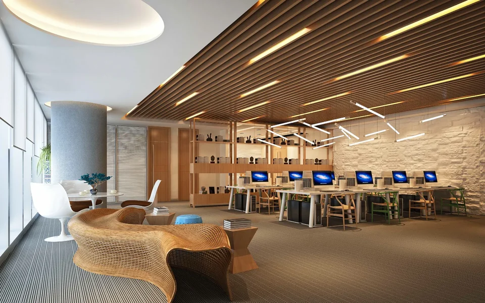 A co-working space with long desks and a reception lounge
