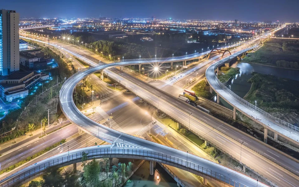 An expressway interchange lit up at night