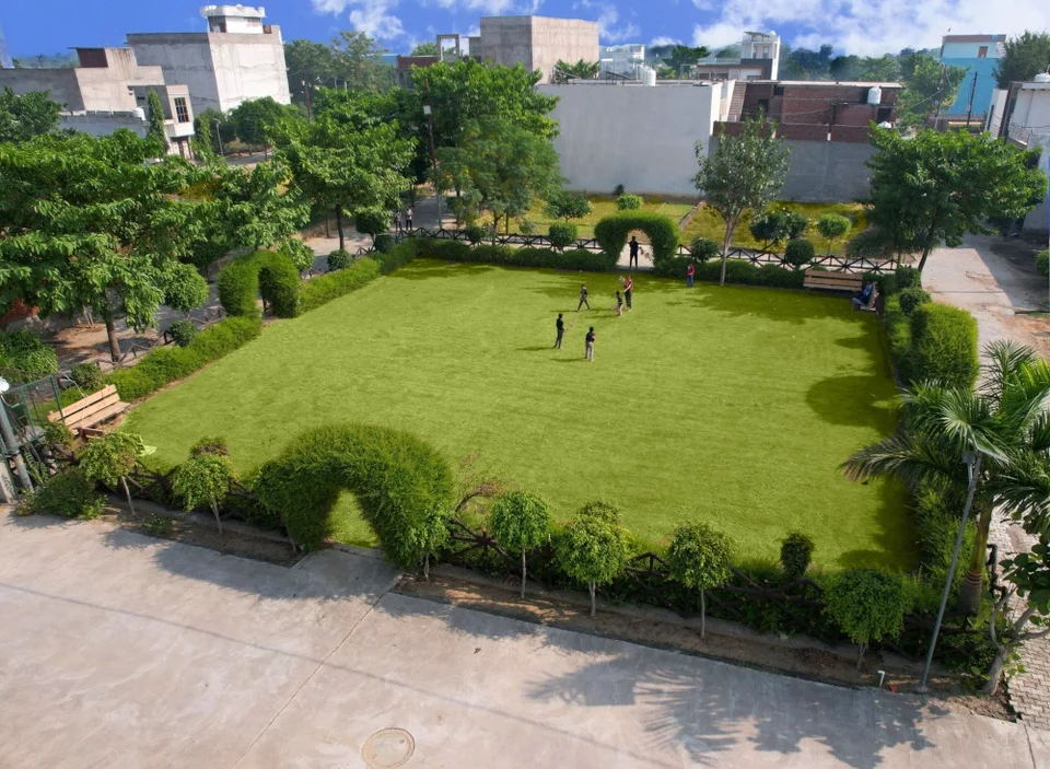 A park with a lawn and hedges seen from above at Mahadev Vihar