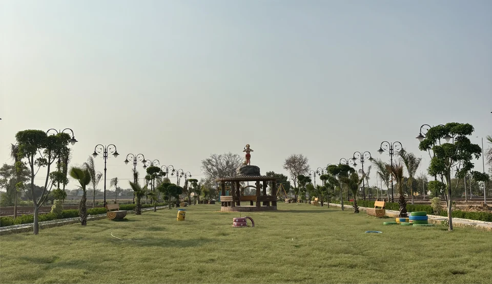 A park with lamps, trees and a gazebo at Shiv Shakti Vihar Phase 2