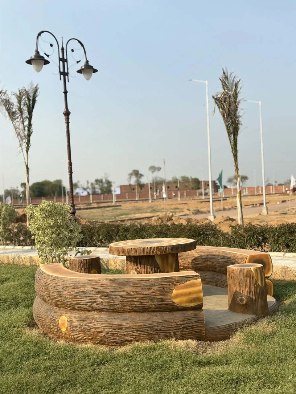 Log-style benches and a table on a lawn