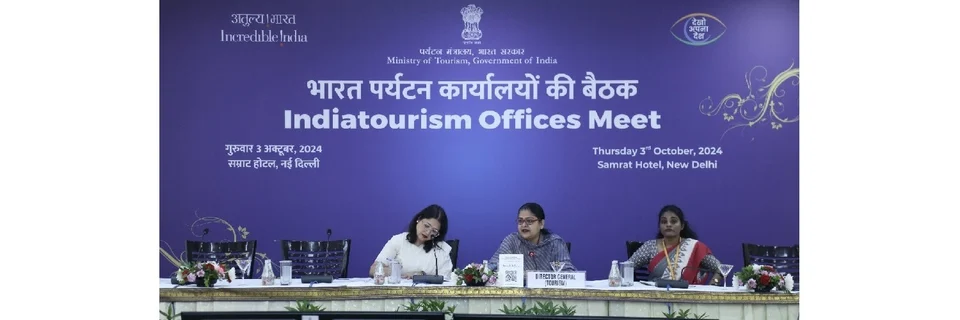 Three women seated at a conference table beneath a purple Ministry of Tourism banner reading 'Indiatourism Offices Meet', Samrat Hotel, New Delhi, 3 October 2024.