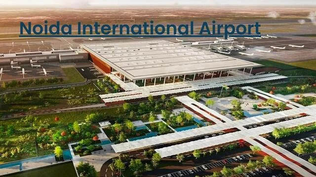Artist's rendering of the Noida International Airport terminal seen from above, with landscaped gardens, covered walkways and parked aircraft, captioned 'Noida International Airport'.